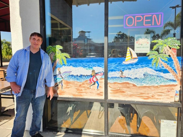 Local artist returns to painting holiday windows after a long illness